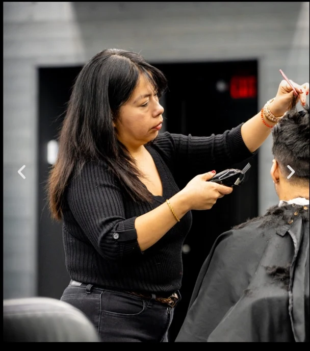 Yesi working behind the barber chair at Social Barber Company