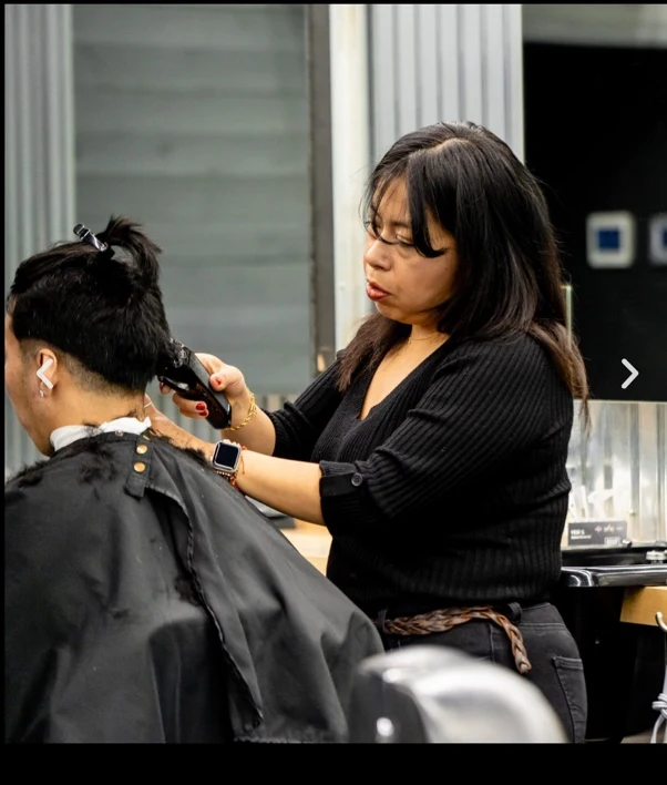 Real photograph from Social Barber's Yesi portfolio showing a haircut in progress